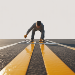 Professional applying a traffic marking stencil to create clear lines on asphalt